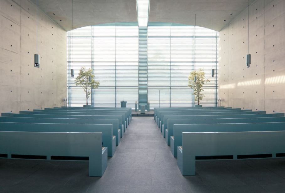 Bare concrete space, resembling a vault, is brought to life by the simple gesture of allowing natural light through the double height column's capitals, giving the sense of lightness to an otherwise very heavy concrete canopy, creating a sublime space in which mourners gather.