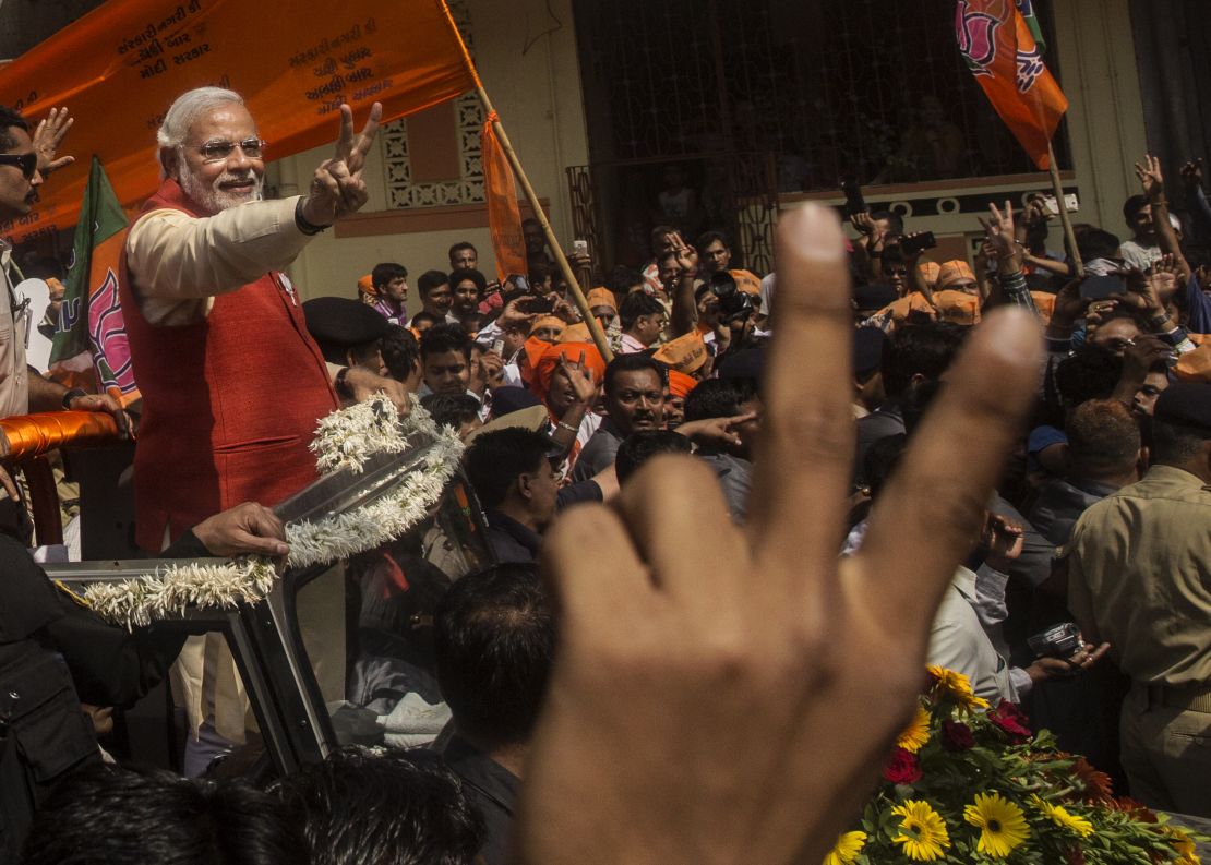 Narendra Modi gestures to his Bharatiya Janata Party (BJP) supporters from an open jeep on April 9, 2014 in Vadodra, India