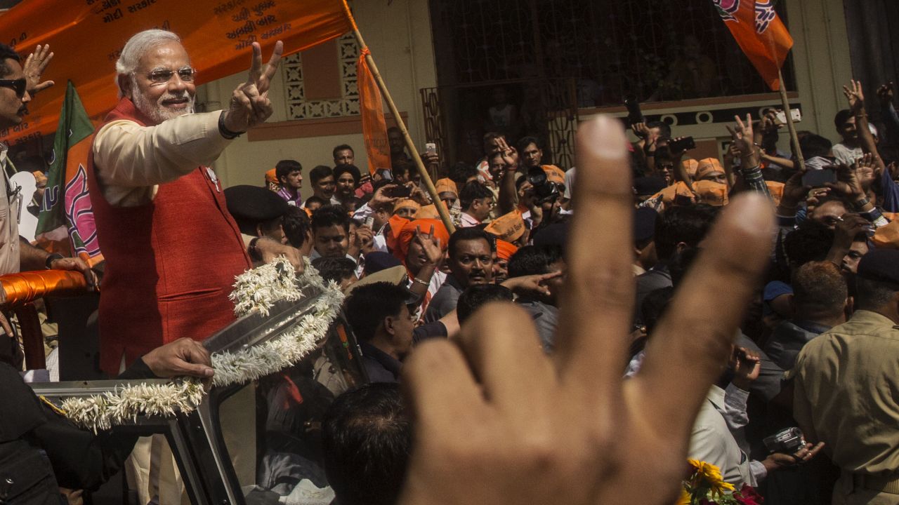 Narendra Modi gestures to his Bharatiya Janata Party (BJP) supporters from an open jeep on April 9, 2014 in Vadodra, India