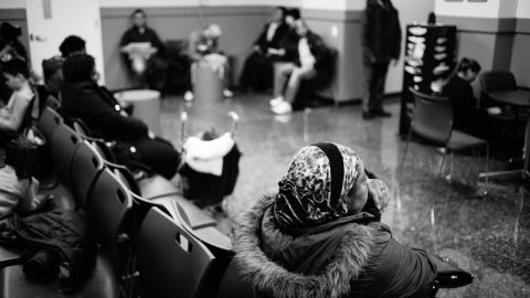 People sit in the waiting room at Catholic Charities during walk-in hours for immigration-related legal services in New York.