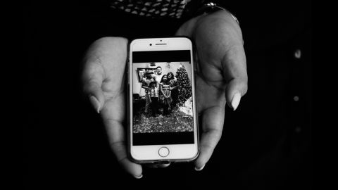 Maribelle shows a photo of her family.