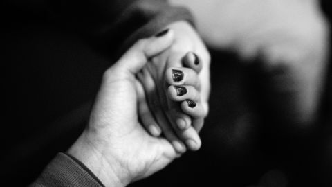 Margarite, an undocumented immigrant from Mexico, holds her daughter's hand.