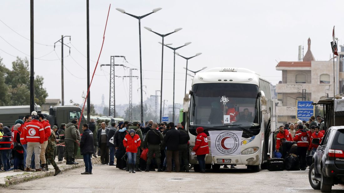 Opposition fighters and their families get on a bus as part of their evacuation from the rebel-held Al-Waer neighborhood in the central city of Homs on Saturday.