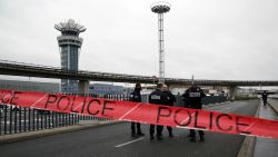 Police officers cordon off the access to the Orly airport, south of Paris, Saturday, March, 18, 2017. A man was shot to death Saturday after trying to seize the weapon of a soldier guarding Paris' Orly Airport, prompting a partial evacuation of the terminal, police said. Authorities warned visitors to avoid the area while an ongoing police operation was underway. 