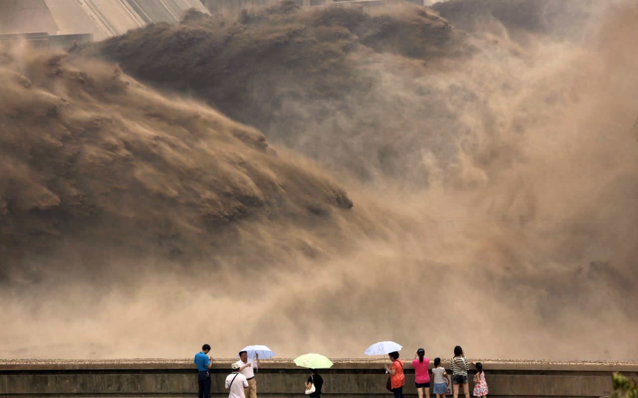 Elsewhere in China, visitors gather to watch giant gushes of water being released from the Xiaolangdi dam to clear up the sediment-laden Yellow river and to prevent localized flooding, in Jiyuan, central China's Henan province. 