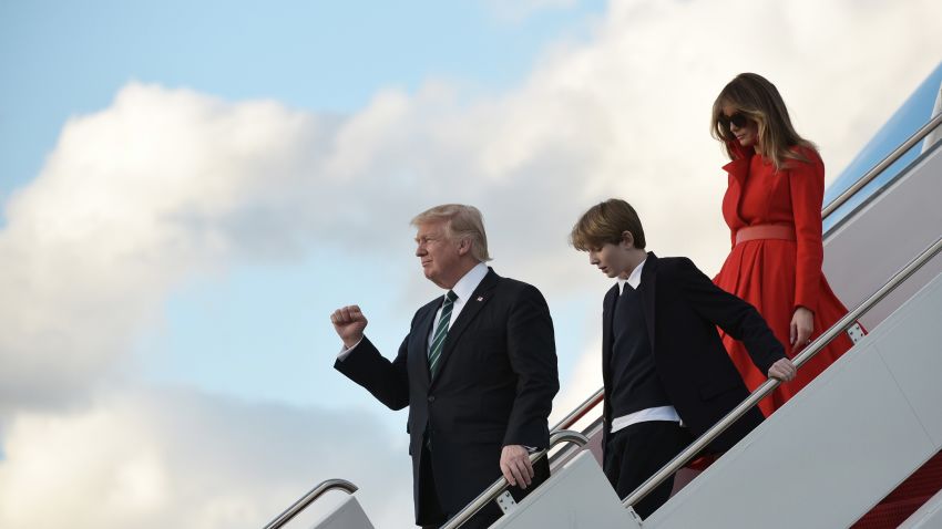 TOPSHOT - US President Donald Trump, son Barron and wife Melania step off Air Force One upon arrival at Palm Beach International Airport in West Palm Beach, Florida on March 17, 2017.Trump is heading to Palm Beach, Florida where he is scheduled to spend the weekend at the Mar-a-Lago estate. / AFP PHOTO / MANDEL NGAN        (Photo credit should read MANDEL NGAN/AFP/Getty Images)