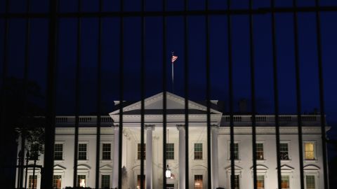 A tall security fence stands in front of the White House in this November 4, 2014, file photo.
