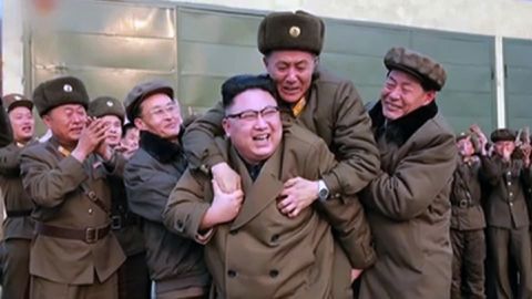 Leader Kim Jong Un is congratulated after the rocket engine test.  