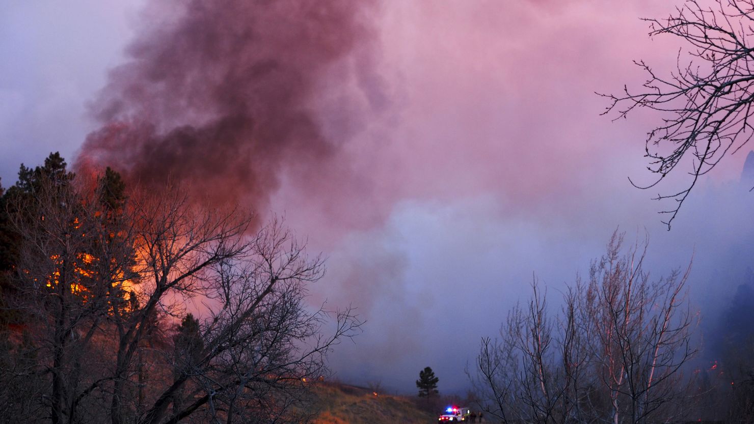 Smoke rises from a wildfire Sunday, March 19, 2017, in Boulder, Colorado. Authorities said the small wildfire burning in the mountains forced people from their homes and is filling the sky with smoke.