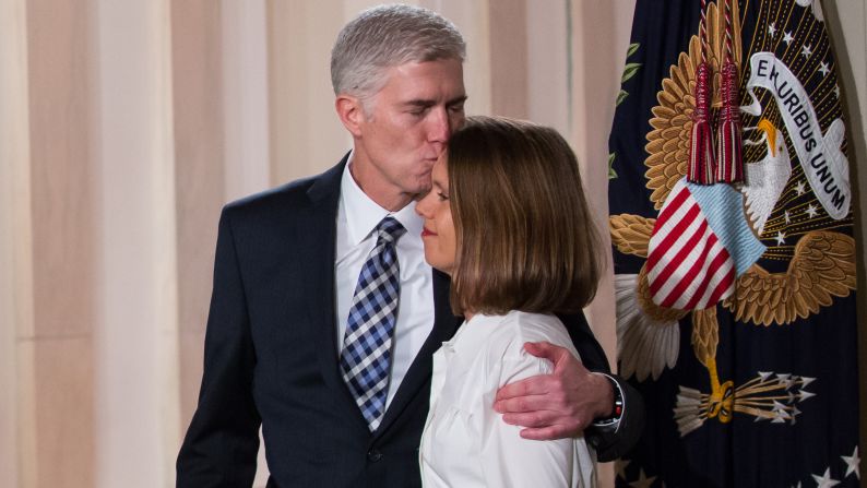 Gorsuch, with his wife by his side, listens to Trump announce his Supreme Court nomination.