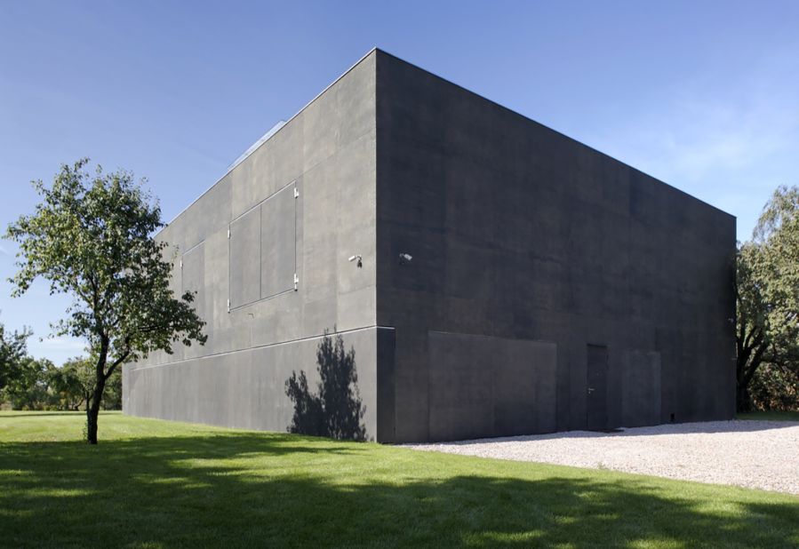 This two-story concrete house, designed by KWK Promes, in Warsaw, Poland, offers maximum security with movable walls,  providing a safety zone.