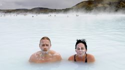 Tourists stand in the Blue Lagoon outside Reykjavik on 26 April, 2009. The Blue Lagoon's blue and green waters come from natural hot water springs flowing through rocks of lava. The lagoon might have some health properties. AFP PHOTO OLIVIER MORIN. (Photo credit should read OLIVIER MORIN/AFP/Getty Images)