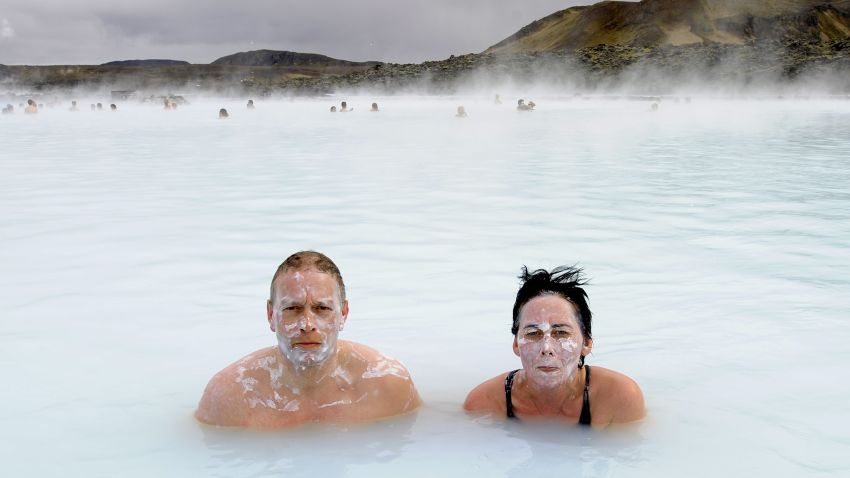 Tourists stand in the Blue Lagoon outside Reykjavik on 26 April, 2009. The Blue Lagoon's blue and green waters come from natural hot water springs flowing through rocks of lava. The  lagoon might have some health properties. AFP PHOTO OLIVIER MORIN. (Photo credit should read OLIVIER MORIN/AFP/Getty Images)