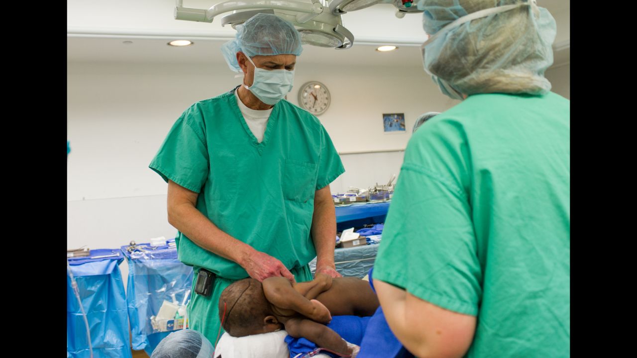 Pediatric neurosurgeon Dr. John Ruge examines Baby Dominique prior to surgery