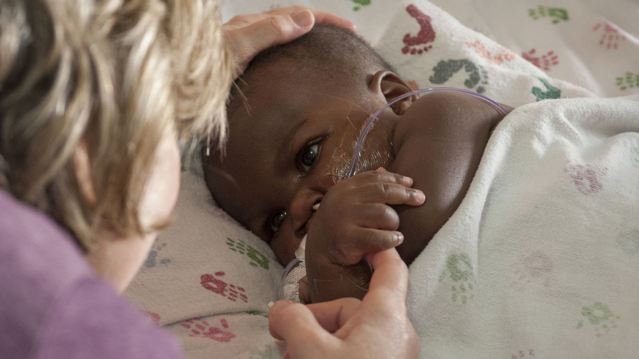 Foster mom Nancy Swabb, visits with Dominique after her surgery.