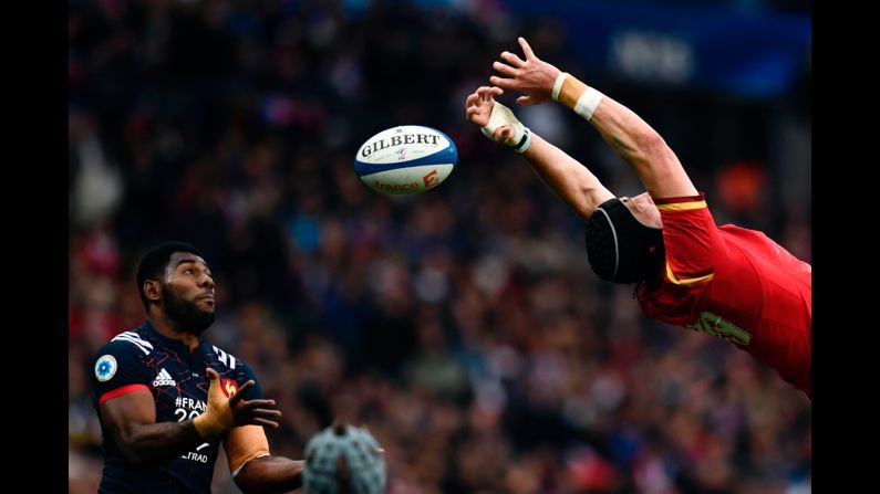 French rugby player Noa Nakaitaci, left, tries to catch the ball as it slips past Wales' Samson Lee during a Six Nations match on Saturday, March 18.
