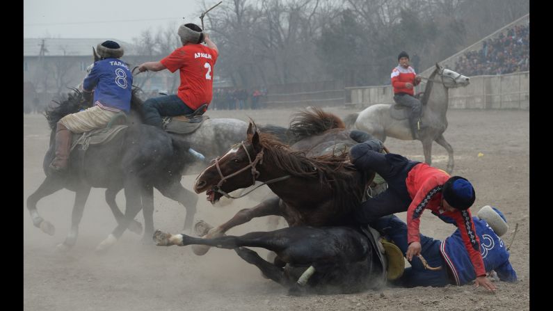 Horsemen play buzkashi during Persian New Year celebrations in Bishkek, Kyrgyzstan, on Thursday, March 16. In buzkashi, players compete to place a goat carcass into a goal circle.