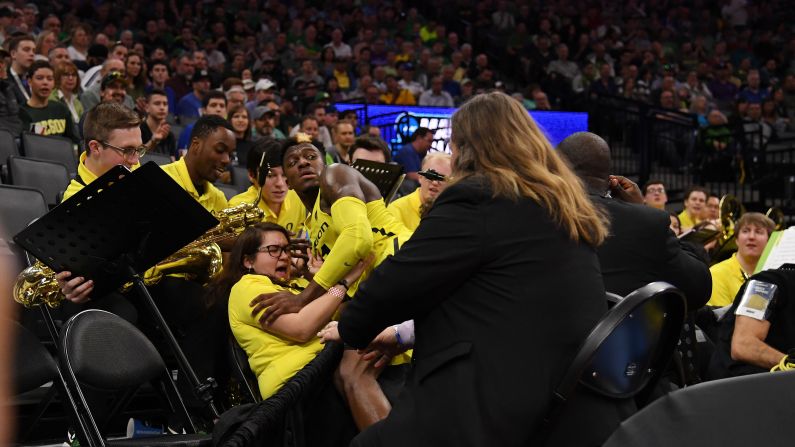 Oregon guard Dylan Ennis collides with band member Raiko Green during an NCAA Tournament game in Sacramento, California, on Friday, March 17.