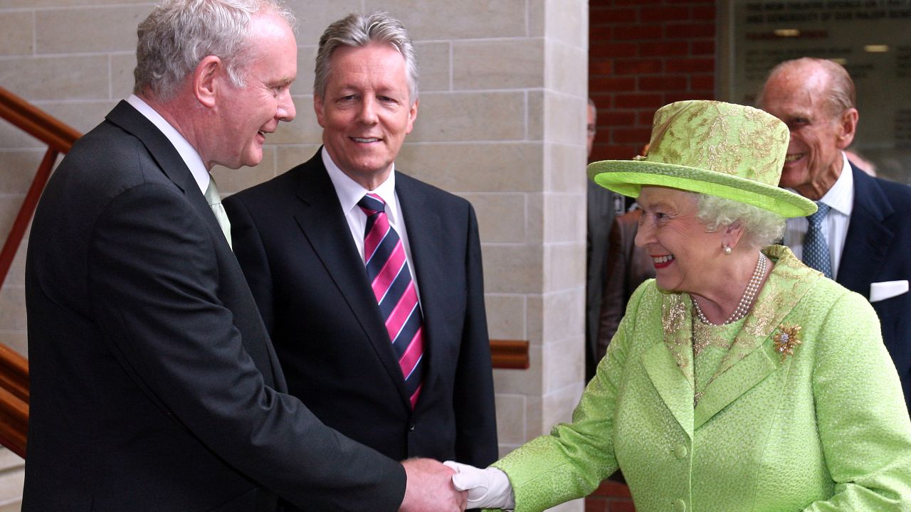 Britain's Queen Elizabeth II (2nd R) shakes hands with Northern Ireland Deputy First Minister Martin McGuinness (L) watched by First Minister Peter Robinson (2nd L) and Prince Philip (R) at the Lyric Theatre in Belfast, Northern Ireland, on June 27, 2012. Queen Elizabeth II shook hands with former IRA commander Martin McGuinness on Wednesday in a landmark moment in the Northern Ireland peace process, Buckingham Palace said. The initial handshake between the queen and McGuinness, who is now deputy first minister of the British province, took place away from the media spotlight behind closed doors in Belfast's Lyric theatre. AFP PHOTO / PAUL FAITH/POOL (Photo credit should read PAUL FAITH/AFP/GettyImages)