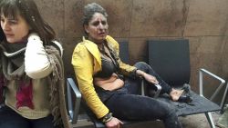 In this March 22, 2016 file photo provided by photographer Ketevan Kardava, Nidhi Chaphekar, a Jet Airways flight attendant from Mumbai, right, and another unidentified woman are shown after being wounded in Brussels Airport in Brussels, Belgium, after explosions rocked the airport. Chaphekar said she has recovered 70 percent of her previous fitness level and would like to resume her passion, flying. (Ketevan Kardava via AP, File)