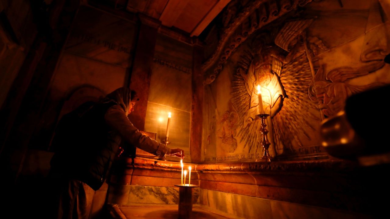 A worshipper prays inside the Edicule surrounding Jesus' tomb. 