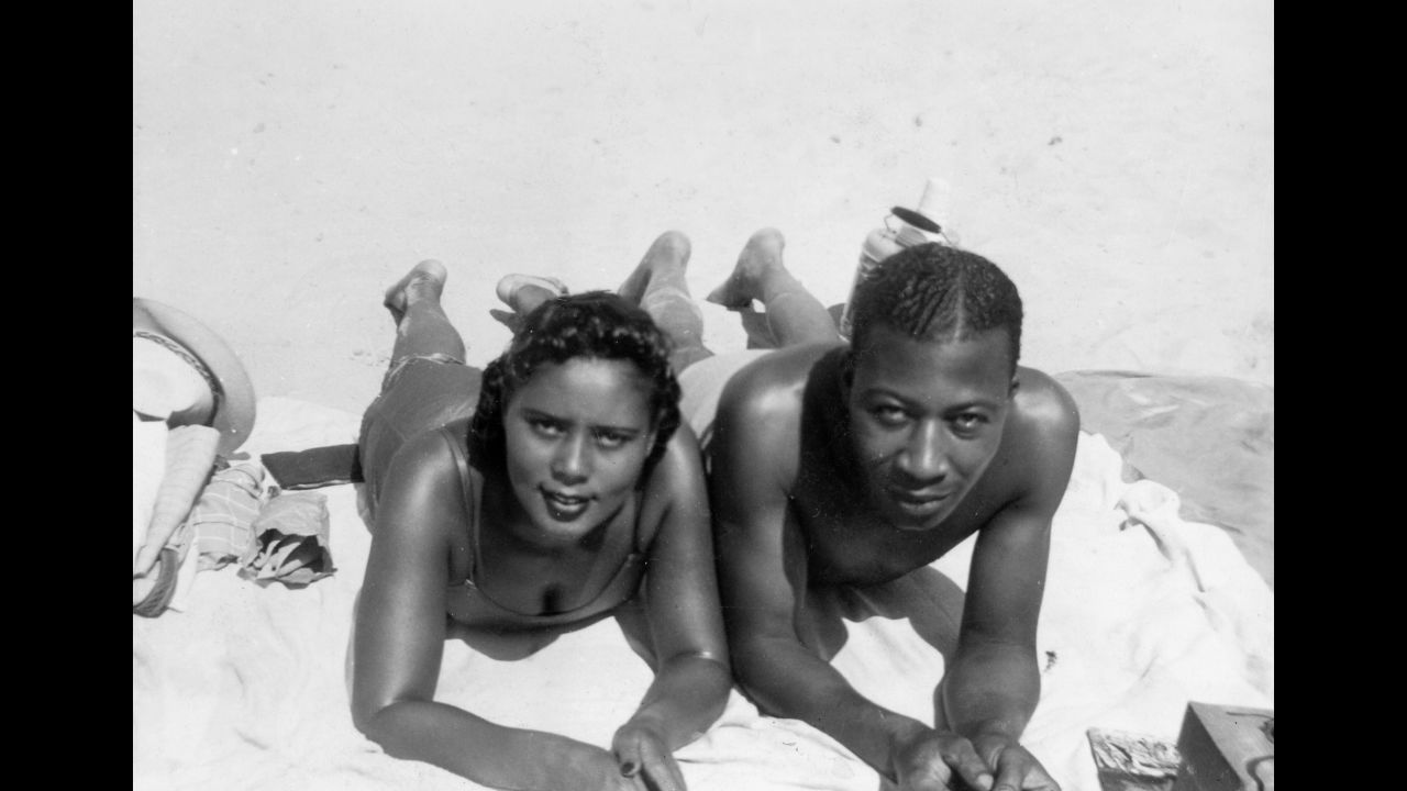 Two people sunbathe at Coney Island. Evans said at the time, there were hardly any women photographers in Brooklyn, much less African-American photographers. "My mother took it as a personal mission to become the historian for this time period because no one else had a camera," he said.