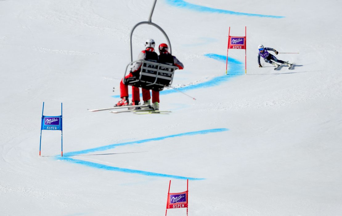 Laura Pirovano is watched by spectators in a chair lift. 