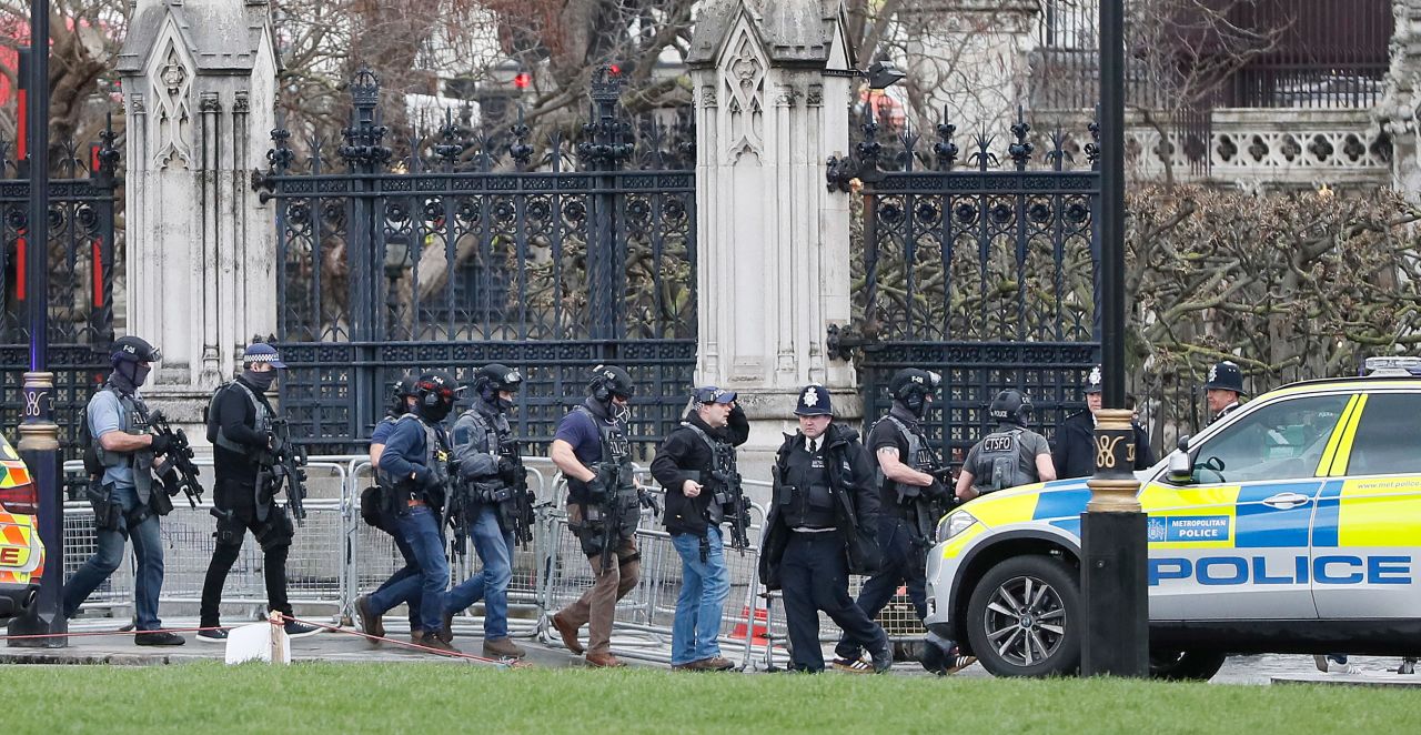 Armed police enter the Houses of Parliament.