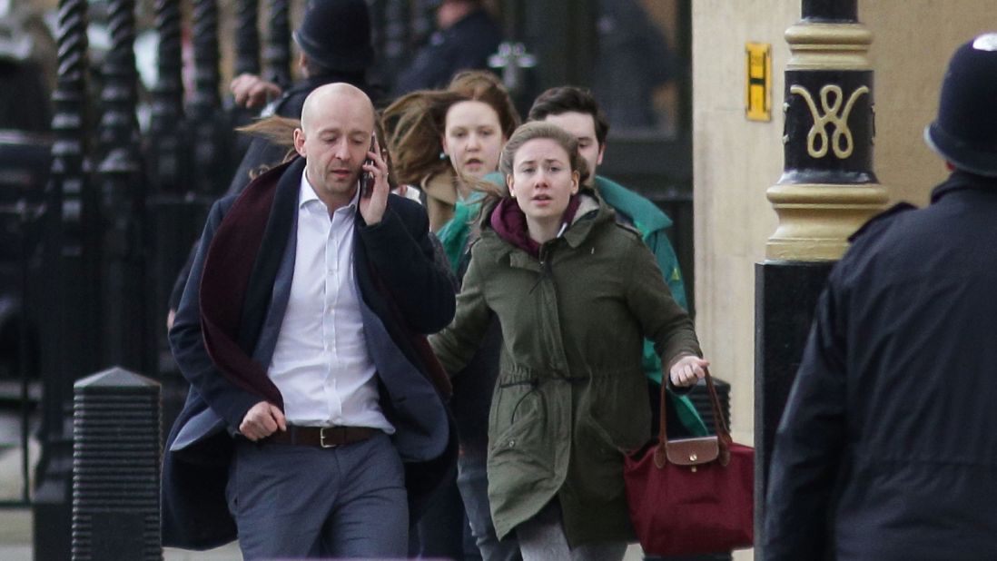 People leave the Parliament building after the incident. Lawmakers were forced to remain in the main debating chamber of the House of Commons as police responded to the incident outside.