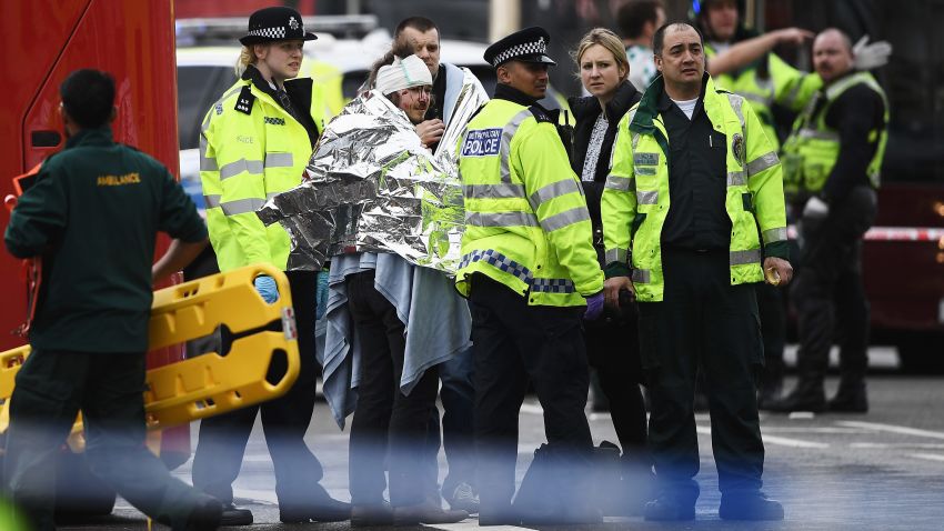 LONDON, ENGLAND - MARCH 22:  A member of the public is treated by emergency services near Westminster Bridge and the Houses of Parliament on March 22, 2017 in London, England. A police officer has been stabbed near to the British Parliament and the alleged assailant shot by armed police. Scotland Yard report they have been called to an incident on Westminster Bridge where several people have been injured by a car.  (Photo by Carl Court/Getty Images)