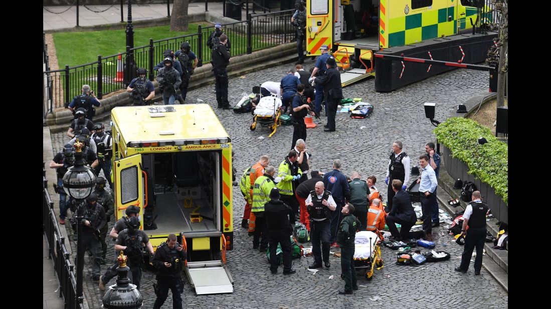 Emergency workers attend to injured people at the scene.