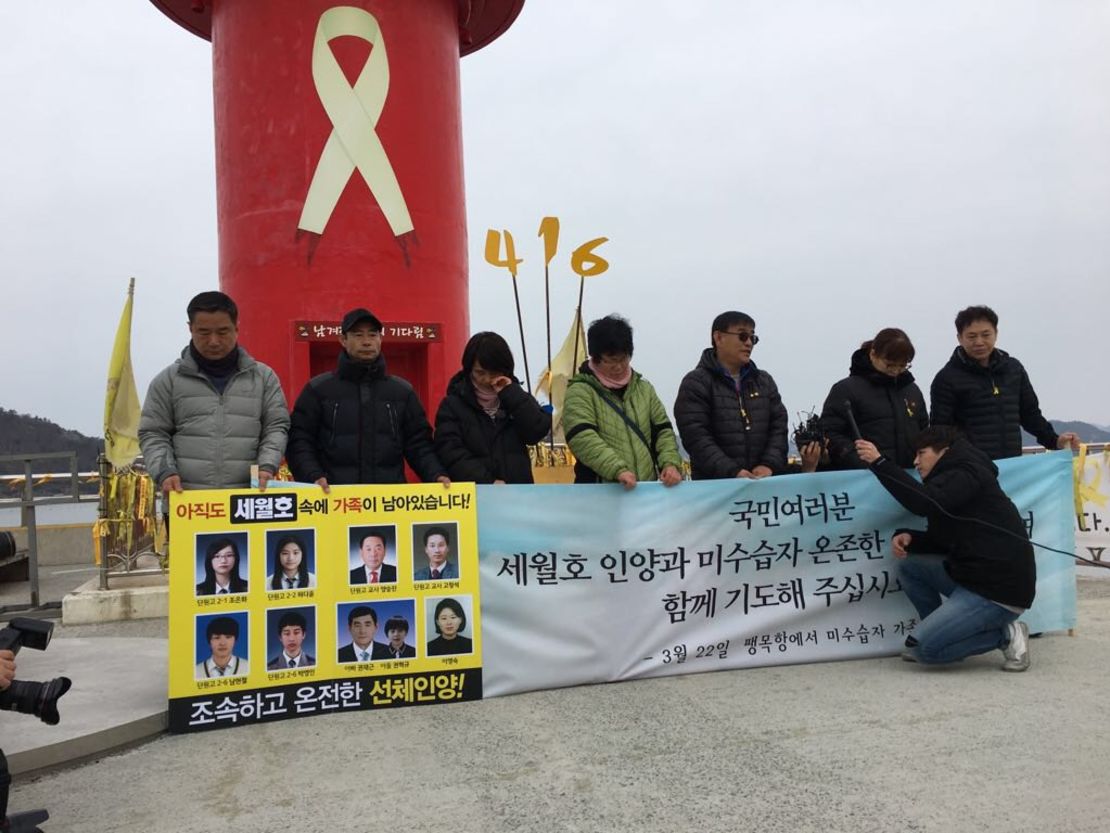 Family members of Sewol ferry victims gather in front of a lighthouse near the site of the sunken vessel.