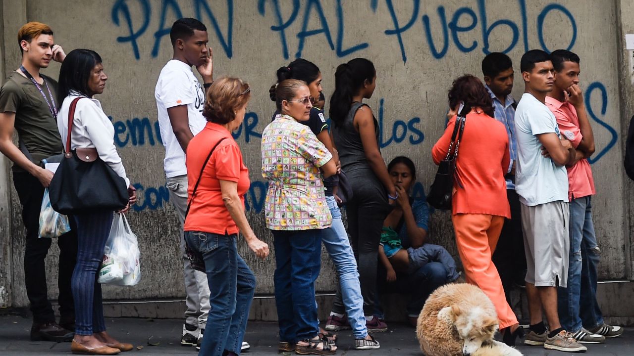 People line up to buy bread in Caracas amid shortages and skyrocketing prices on all types of goods.