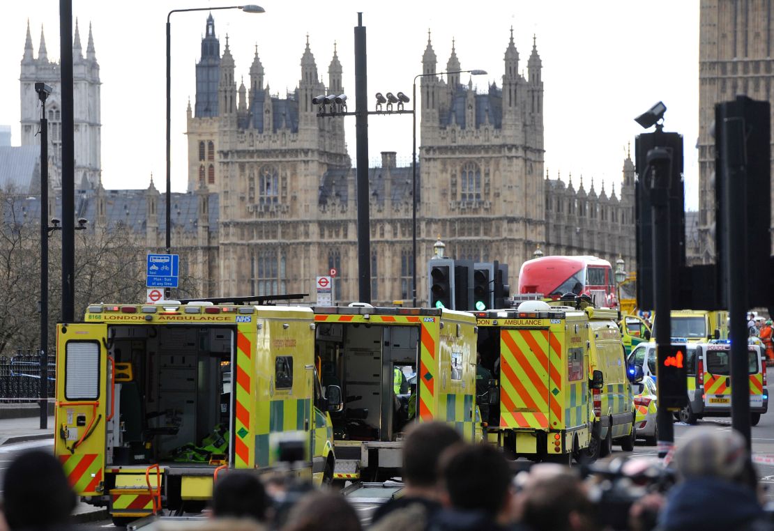Ambulances wait as medics aid people on Westminster Bridge, near Parliament in central London, after an attack on March 22.