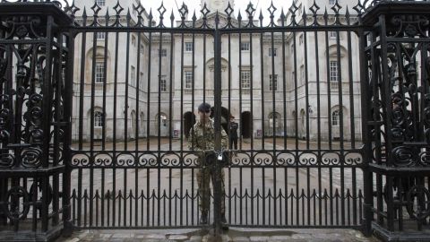 A soldier chains the gate at Horse Guards after Wednesday's terror attack. The entrances to Downing Street and Buckingham Palace were also closed as precautions.