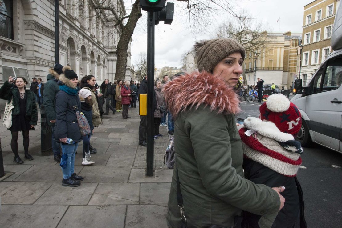 People watch as police secure the area north of Parliament Square.