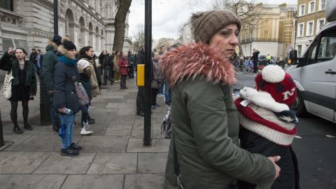 People watch as police secure the area north of Parliament Square.