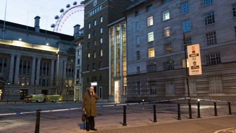 A man talks on a cellphone near the London Eye, where tourists were held on the sightseeing attraction during the incident.