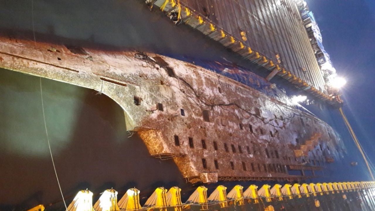 One of the first images of the Sewol ferry as it emerges after three years underwater.