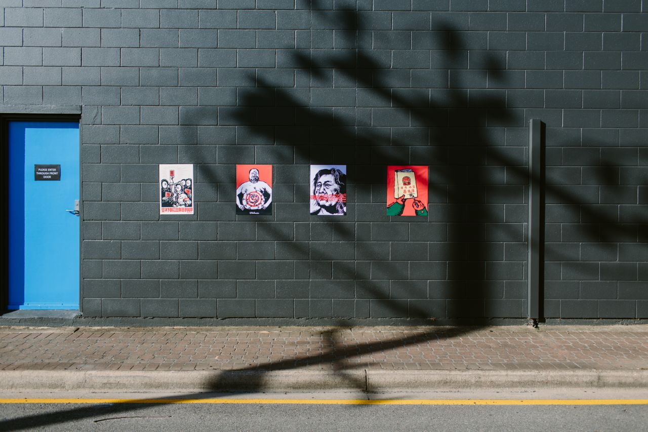 Cartoons of Ai Weiwei and jailed Chinese journalist Gao Yu outside Badiucao's Adelaide gallery show