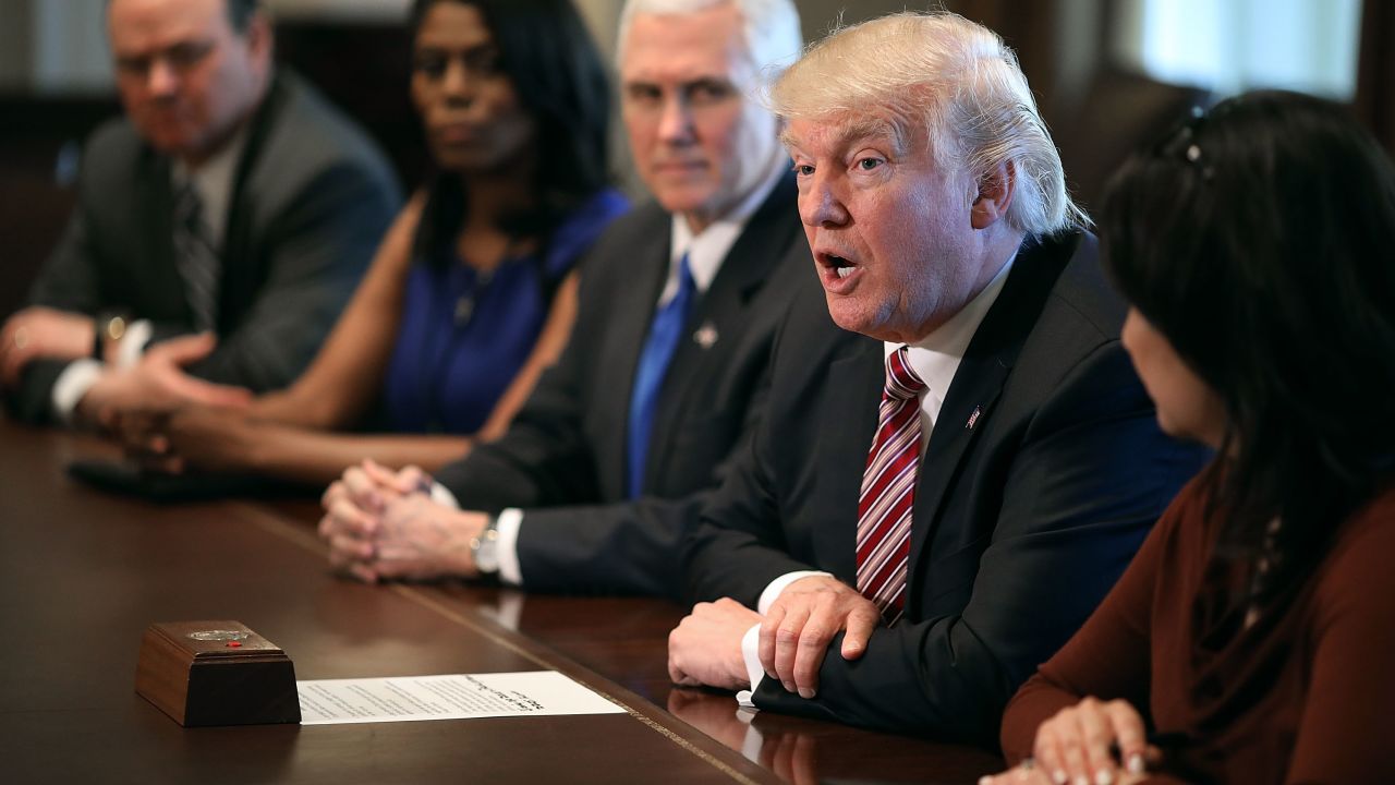 WASHINGTON, DC - MARCH 22:  (AFP OUT) U.S. President Donald Trump (2nd R) is joined by Vice President Mike Pence, White House Director of Communications for the Office of Public Engagement and Intergovernmental Affairs Omarosa Manigault and other staff members during a meeting with the Congressional Black Caucus Executive Committee in the Cabinet Room at the White House March 22, 2017 in Washington, DC. During the 2016 presidential campaign, Trump asked African Americans to support him, saying, "You're living in poverty, your schools are no good, you have no jobs, 58 percent of your youth is unemployed -- what the hell do you have to lose?"  (Photo by Chip Somodevilla/Getty Images)