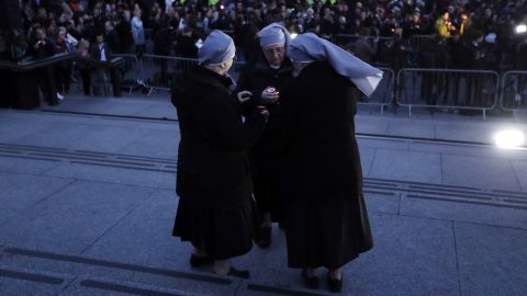 A group of nuns light candles during the Trafalgar Square event.