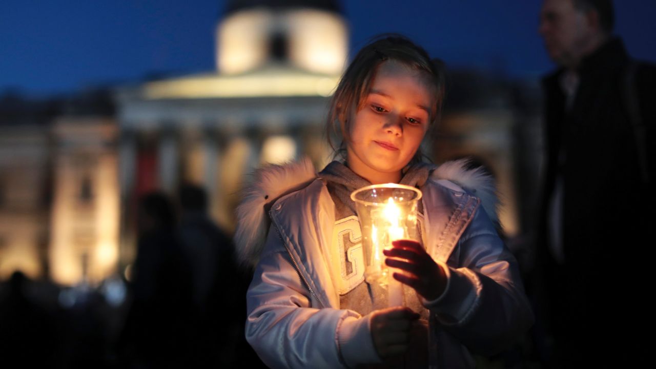 A young girl holds a candle during the vigil.