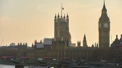 A picture shows red London buses, pedestrians and traffic crossing Westminster Bridge over the River Thames with the Union flag atop the Houses of Parliament (R) flying at half-mast in central London on March 23, 2017. 
Britain's parliament reopened on Thursday with a minute's silence in a gesture of defiance a day after an attacker sowed terror in the heart of Westminster, killing three people before being shot dead. Sombre-looking lawmakers in a packed House of Commons chamber bowed their heads and police officers also marked the silence standing outside the headquarters of London's Metropolitan Police nearby.
 / AFP PHOTO / Niklas HALLE'N        (Photo credit should read NIKLAS HALLE'N/AFP/Getty Images)