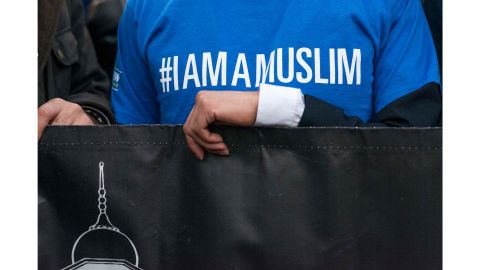 Members of the Ahmadiyya Muslim Community, which started the hashtag campaign #IAmAMuslim, hold a banner during the vigil.