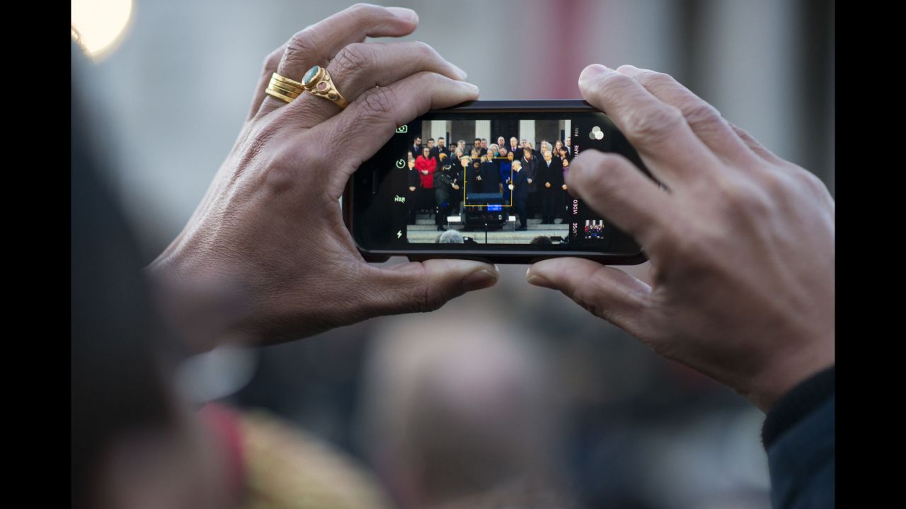 A person in the crowd captures a moment from the memorial ceremony on the steps of Trafalgar Square.
