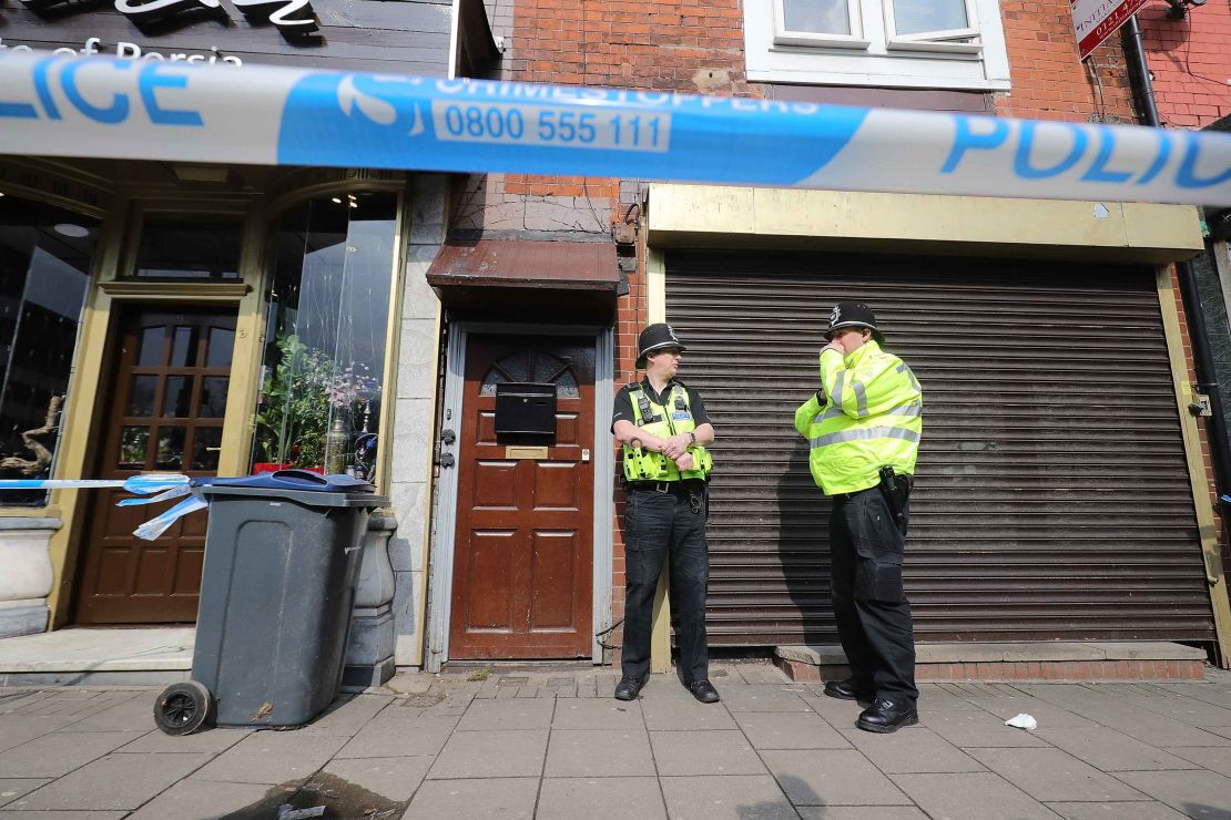 Police stand guard Thursday at the entrance to an apartment on Hagley Road in Birmingham.