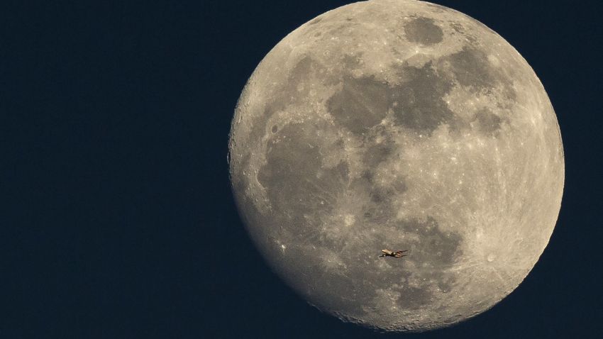 LONDON, ENGLAND - MARCH 03:  A plane flies past the moon at sunset on March 3, 2015 in London, England.  (Photo by Dan Kitwood/Getty Images)