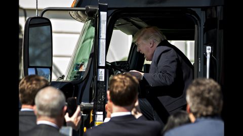 President Trump pretends to drive a truck during an event with truckers and truck industry executives on the South Lawn of the White House on Thursday, March 23.