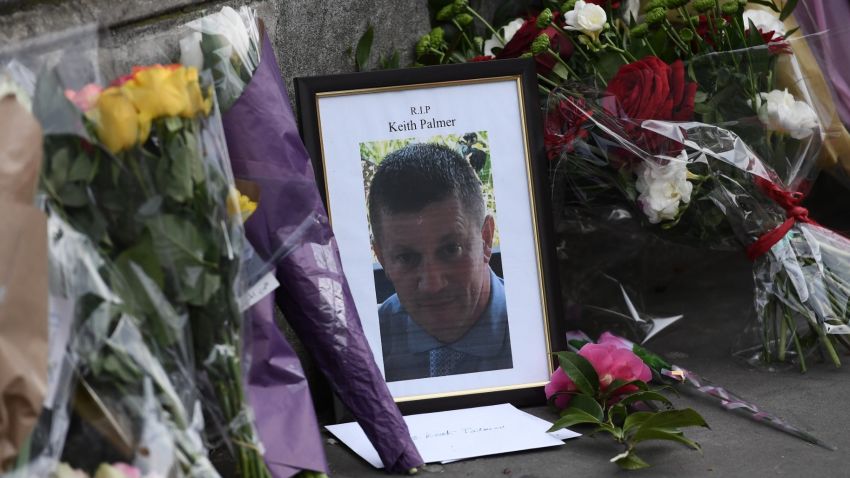 LONDON, ENGLAND - MARCH 23:  Flowers are left with a memorial to Police Constable Keith Palmer who was stabbed as he tried to stop an attacker in a courtyard outside the Houses of Parliament yesterday, on March 23, 2017 in London, England. Four people including the assailant have been killed and around 40 people injured following yesterday's attack by the Houses of Parliament in Westminster.  (Photo by Carl Court/Getty Images)